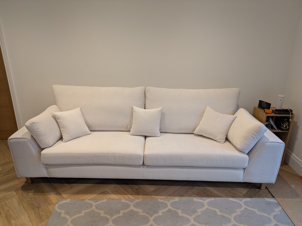 Wide cream bespoke sofa in a room