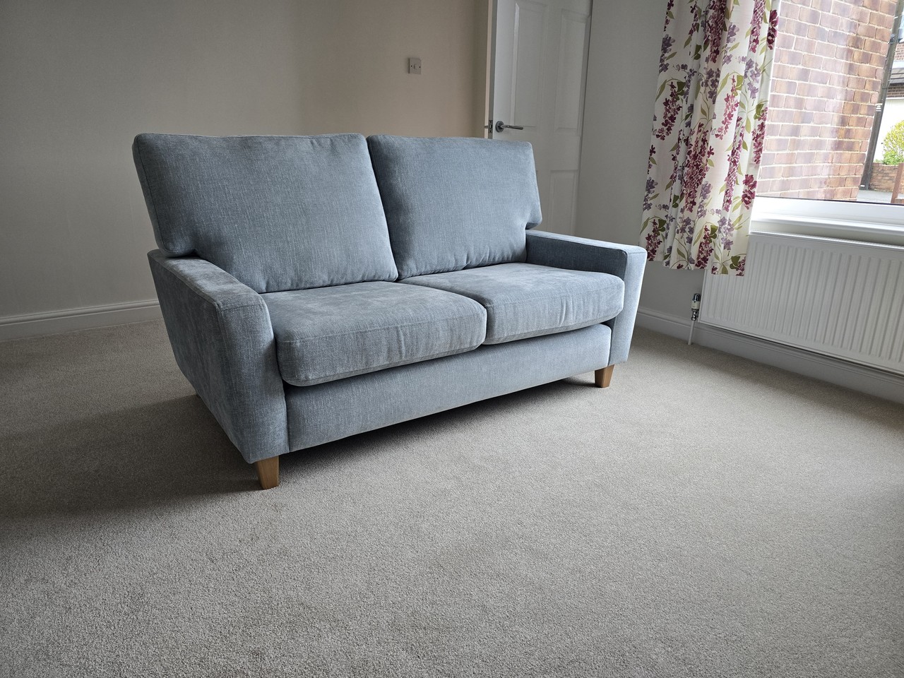 Pale blue Sorrento sofa with slim arms in a furnished room