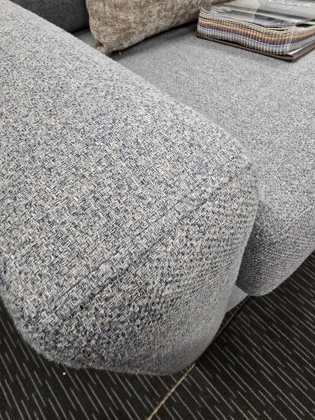 Close-up of real woven upholstery and an arm detail