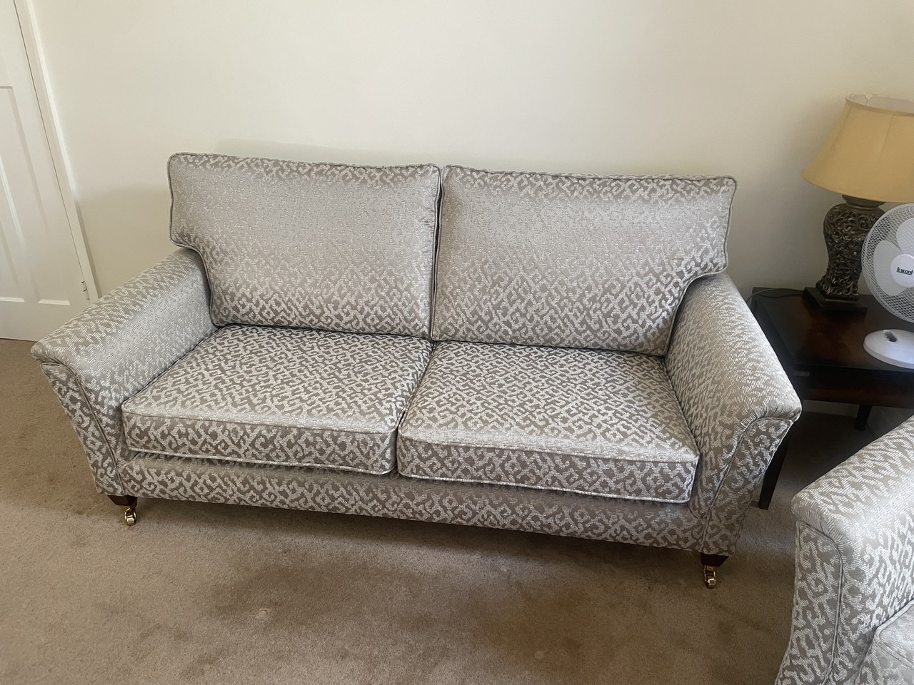 Pale patterned Courtney sofa with two back cushions, two seat cushions and gently flared arms.