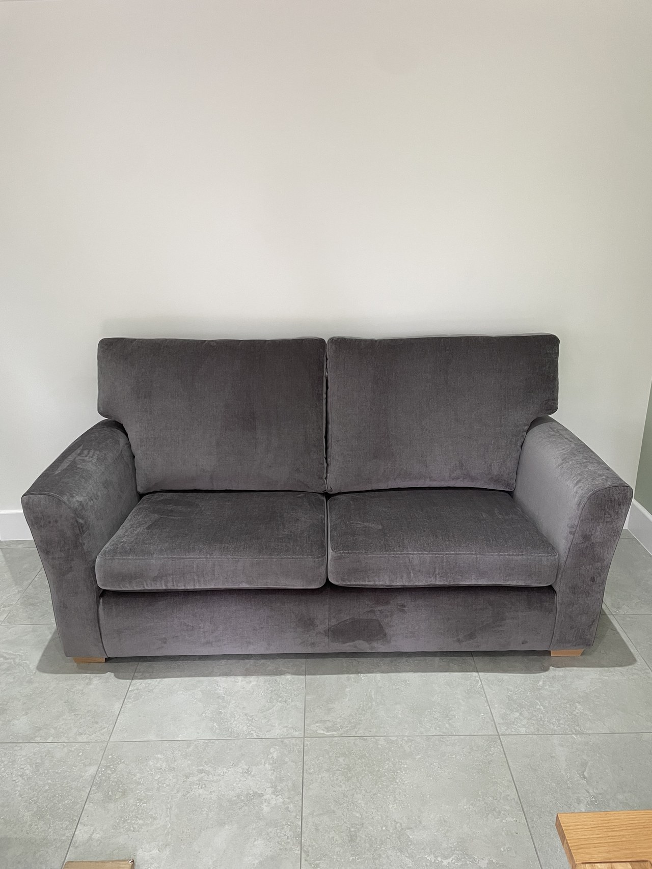 Grey Shelly sofa with two broad back cushions and softly flared arms.