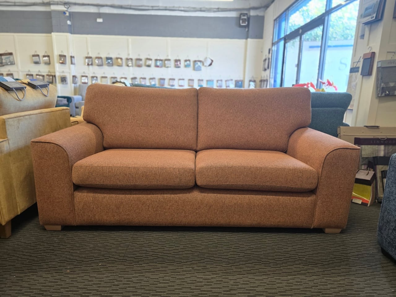Orange Otto three-seater seen from the front in the showroom
