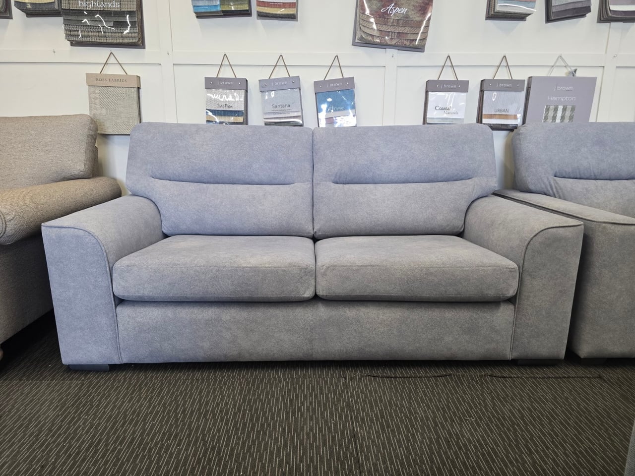 Front view of the light blue Otto three-seater with split-back cushions