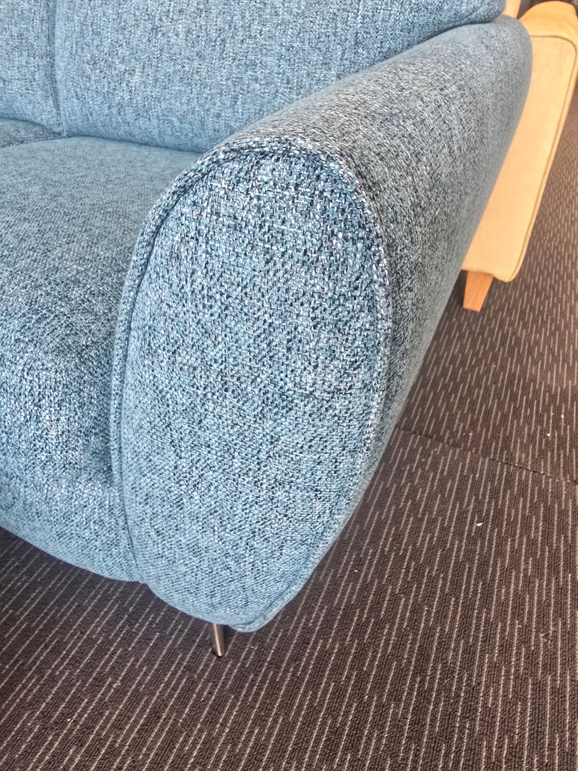 Close-up of the Clifton’s blue teal fabric and rounded arm front